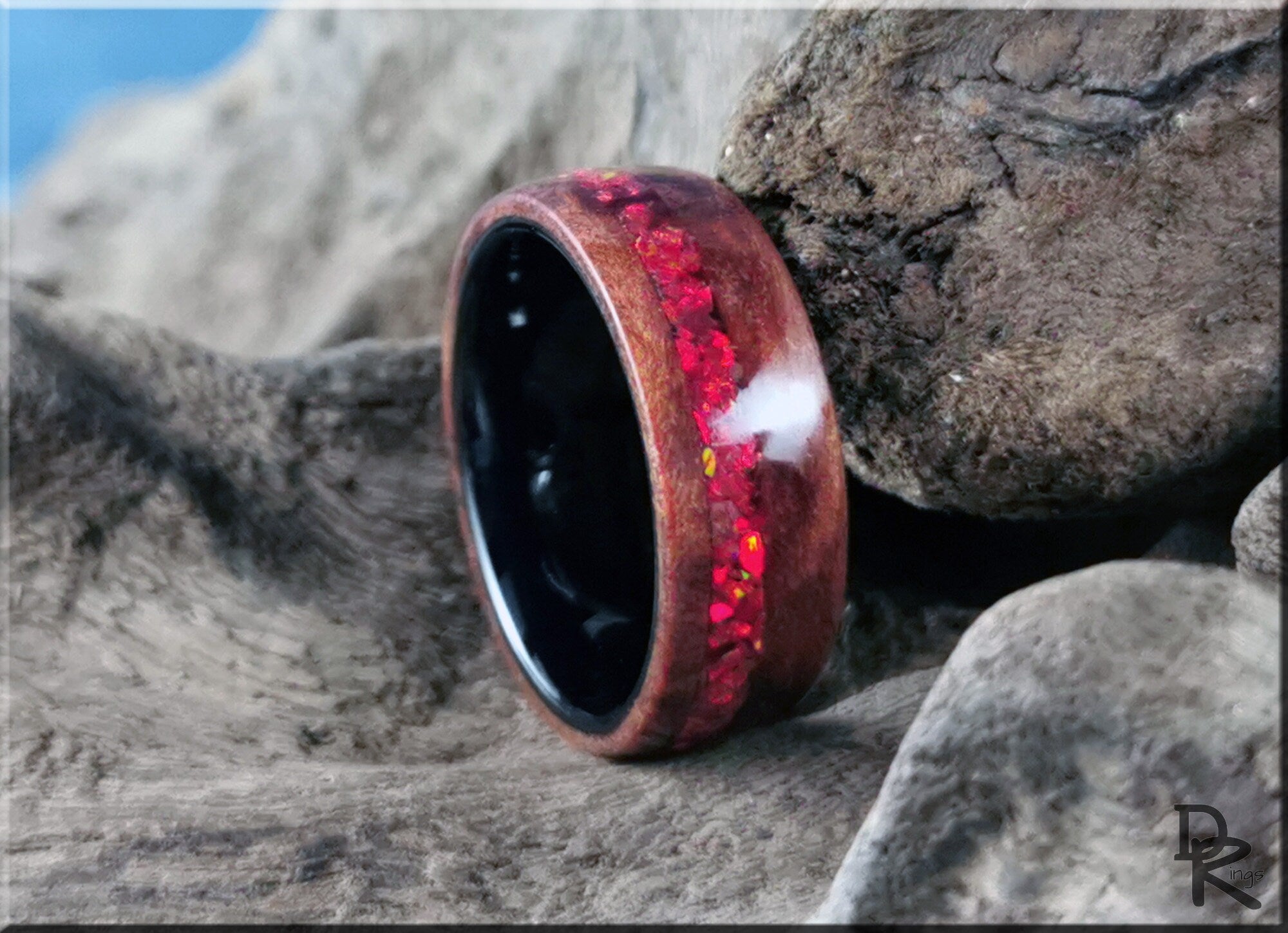 Wood ring with opal inlay featuring vibrant red opal details on a polished wooden band by DR Rings