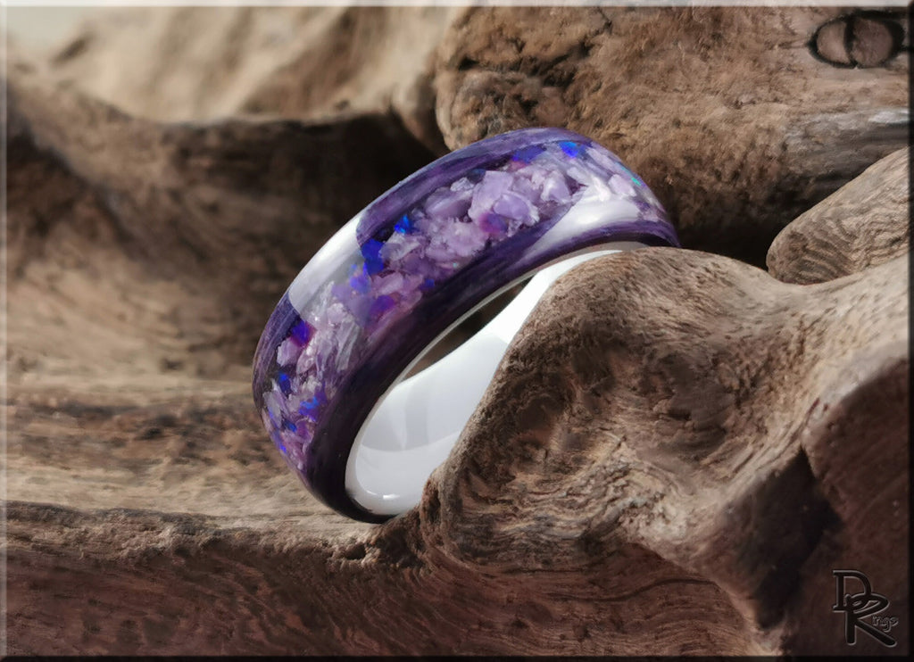 DR Rings wood ring with opal inlay featuring purple and blue hues on a natural wood background
