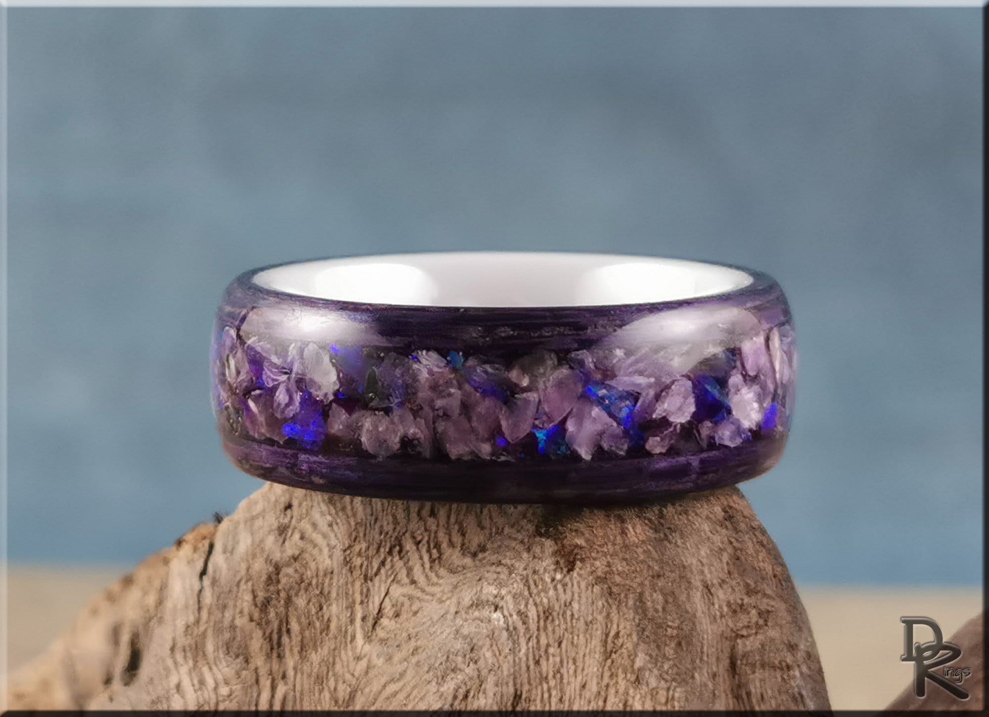 Wood ring with opal inlay featuring purple and blue opal fragments in a polished design by DR Rings