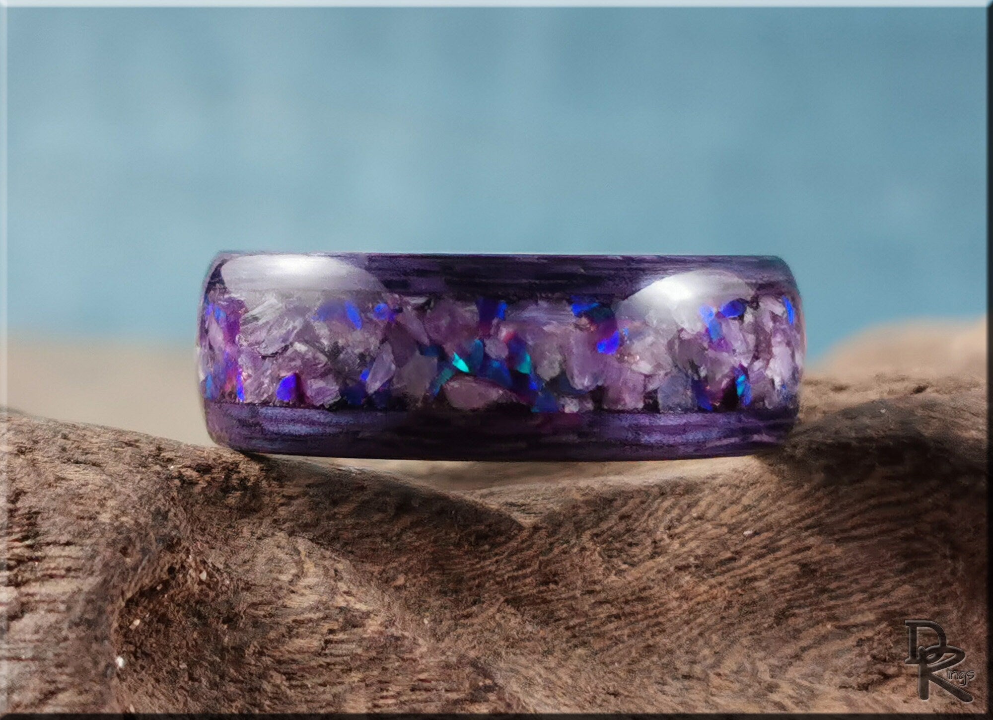 DR Rings wood ring with opal inlay featuring purple and blue opal accents on a wooden surface