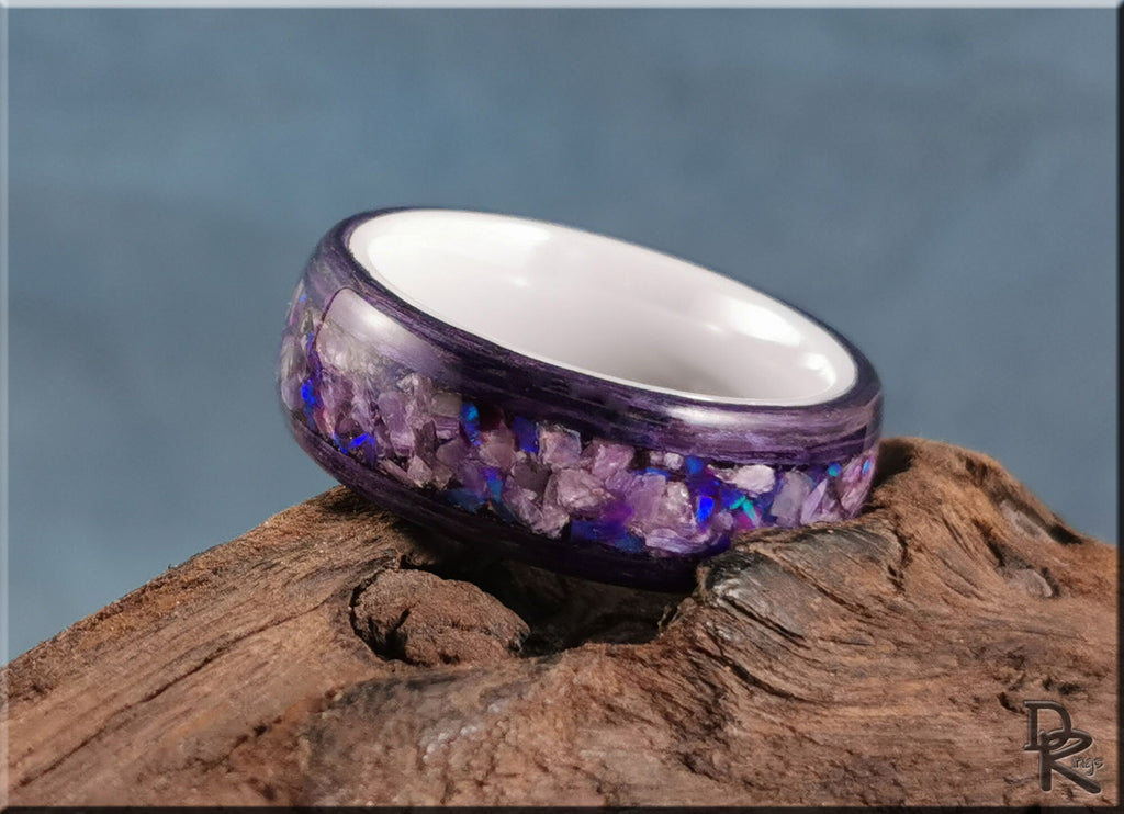 DR Rings wood ring with opal inlay featuring purple and blue tones on natural wood background