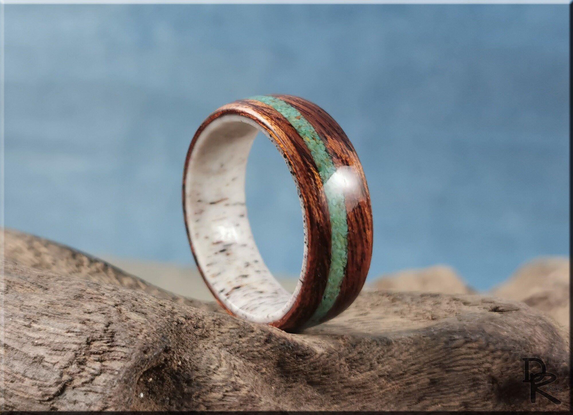 DR Rings wood ring with turquoise and antler inlay on natural wood background