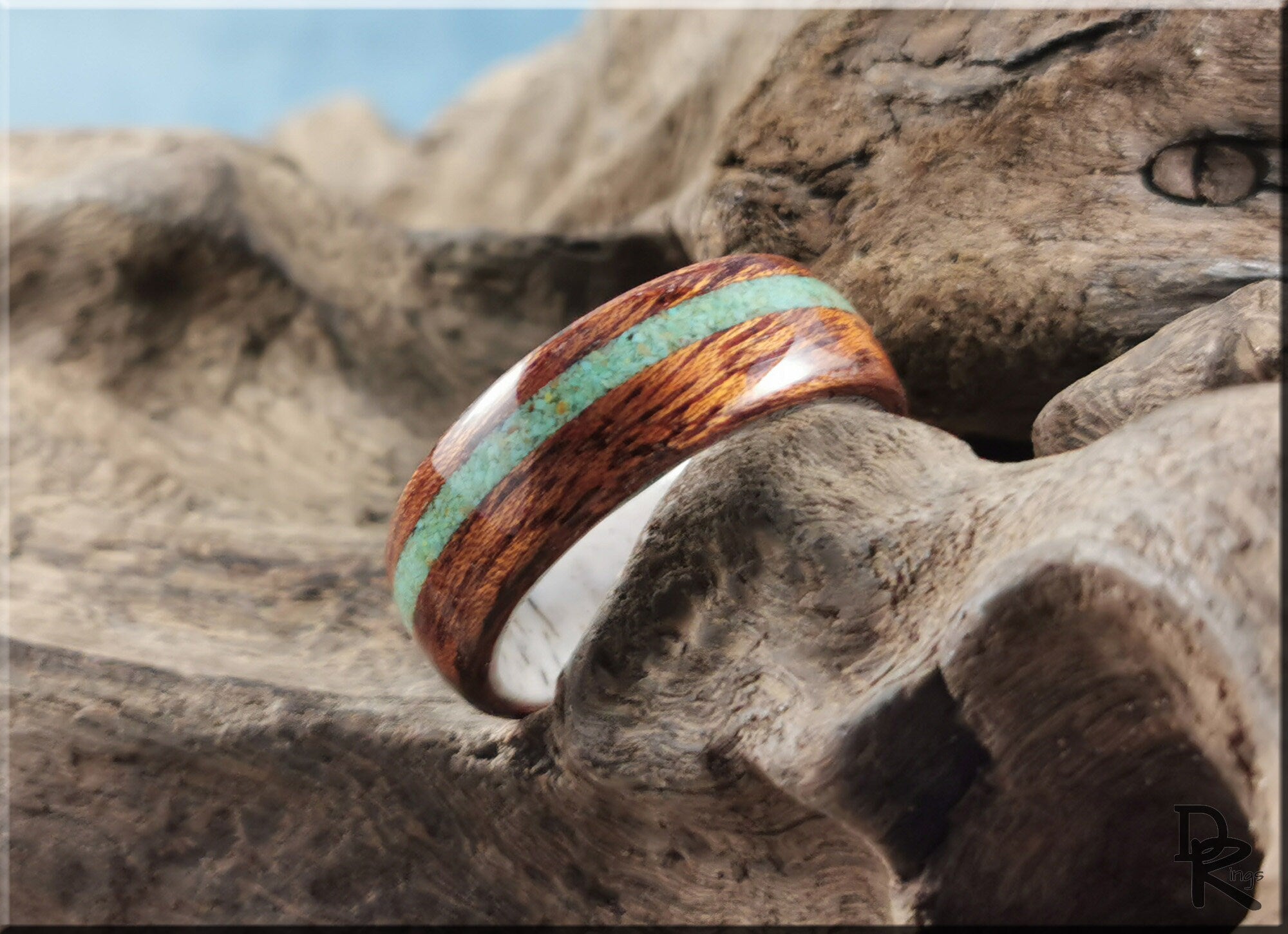 Wood ring with turquoise and antler featuring a polished wooden band with a turquoise inlay by DR Rings